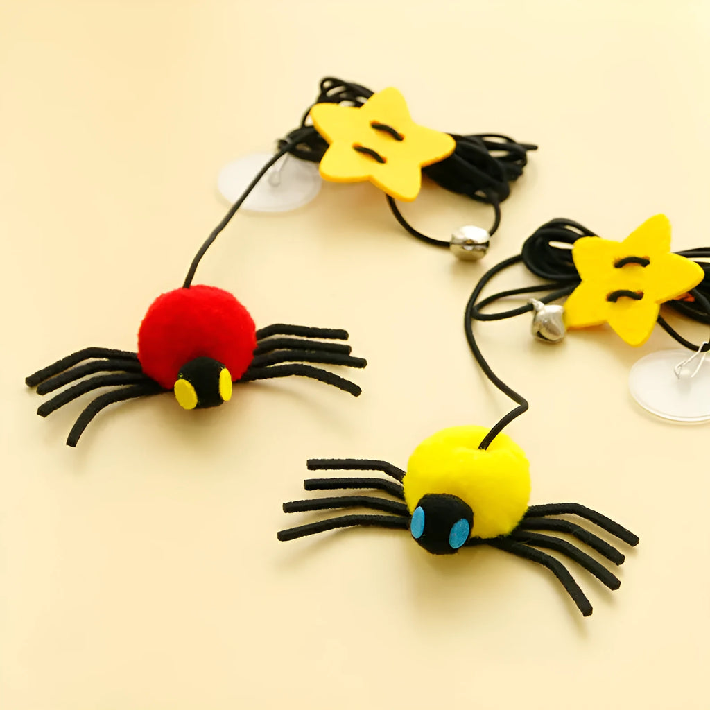 Hanging cat toy with red elastic rope, feather, and bell spider attachment mounted on door